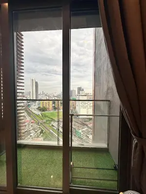 a room with a window with a view of a city at Lucentia Residences By CasaLuxe in Kuala Lumpur