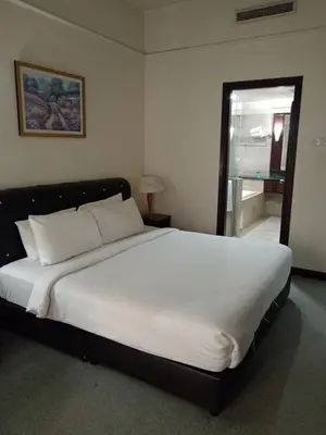a bedroom with a large white bed with a window at Times Apartment at Times Square in Kuala Lumpur