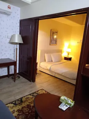 a bedroom with a bed and a table and a mirror at Times Apartment at Times Square in Kuala Lumpur