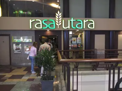 people standing outside of a restaurant in a building at Times Apartment at Times Square in Kuala Lumpur