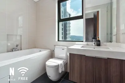 a bathroom with a toilet and a sink and a tub at Gleneagles Hospital - 3BR with Pool & Near KLCC in Kuala Lumpur