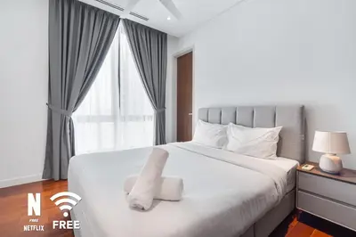a bedroom with a large white bed with a window at Gleneagles Hospital - 3BR with Pool & Near KLCC in Kuala Lumpur