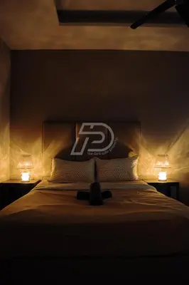 a bedroom with a bed with two lights on it at Dorsett Hartamas KL, Bathtub Smart TV & WiFi in Kuala Lumpur