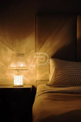 a bedroom with a bed with a lamp on a night stand at Dorsett Hartamas KL, Bathtub Smart TV & WiFi in Kuala Lumpur
