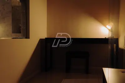 a desk in a room with a lamp and a chair at Dorsett Hartamas KL, Bathtub Smart TV & WiFi in Kuala Lumpur