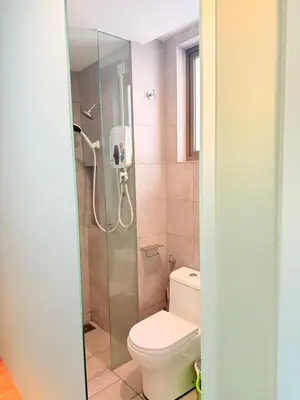 a bathroom with a toilet and a glass shower at The Sentral Nook KL Sentral By Riveria city in Kuala Lumpur