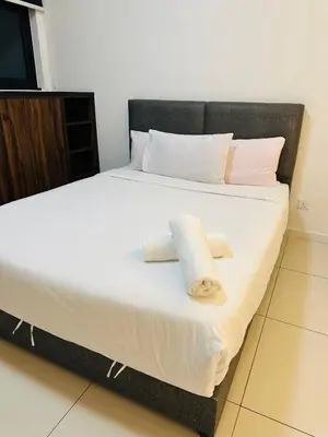 a bedroom with a bed with two towels on it at Chamber Haven KL in Kuala Lumpur