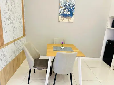 a dining room table with two chairs and a table at Chamber Haven KL in Kuala Lumpur