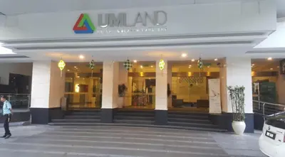 a woman walking in front of a building at Suasana Suites by Lisa in Kuala Lumpur