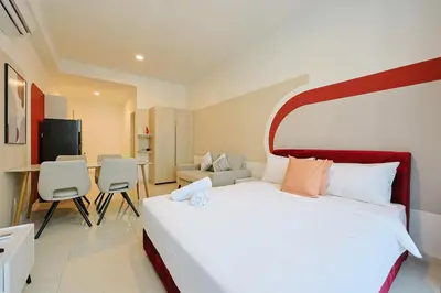 a bedroom with a large bed and a living room at Majestic Residence Home Plus in Kuala Lumpur