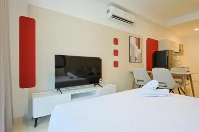 a bedroom with a white bed and a flat screen tv at Majestic Residence Home Plus in Kuala Lumpur