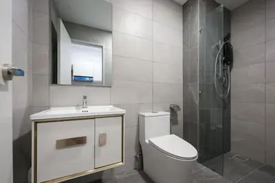 a bathroom with a toilet and a sink and a shower at Majestic Residence Home Plus in Kuala Lumpur