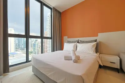 a bedroom with a bed with a teddy bear on it at Majestic Residence Home Plus in Kuala Lumpur