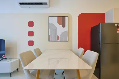 a dining room with a white table and a refrigerator at Majestic Residence Home Plus in Kuala Lumpur