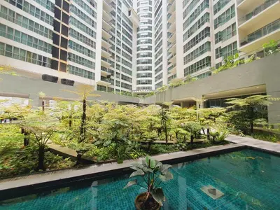 a swimming pool in a building with tall buildings at Amazing KLCC View @ Regalia Residence in Kuala Lumpur