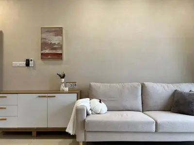 a living room with a couch with a teddy bear on it at Trion KL By AlwaysHome in Kuala Lumpur