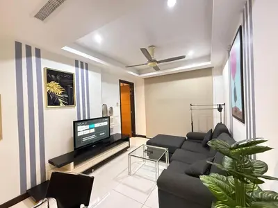 a living room with a black couch and a flat screen tv at 0710 Sweet Home-Casa Residency 2R 2B in Kuala Lumpur