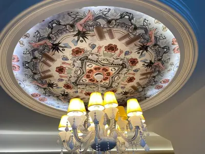 a chandelier with a painting on a ceiling at Stylish 2 bedroom duplex bedroom city center in Kuala Lumpur