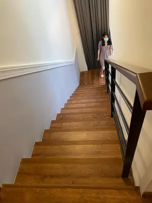 a woman walking down a stairs with a mask on her face at Stylish 2 bedroom duplex bedroom city center in Kuala Lumpur