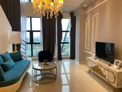 a living room with a blue couch and a tv at Stylish 2 bedroom duplex bedroom city center in Kuala Lumpur