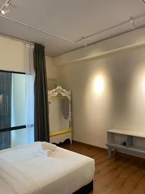 a bedroom with a white bed and a window at Stylish 2 bedroom duplex bedroom city center in Kuala Lumpur