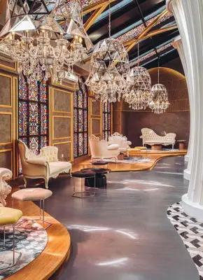 a room with chandeliers and chairs and tables at Stylish 2 bedroom duplex bedroom city center in Kuala Lumpur