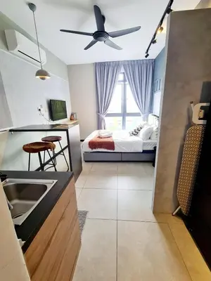 a kitchen with a sink and a bed in a room at Compact Studio Near Gleneagles KLCC in Kuala Lumpur