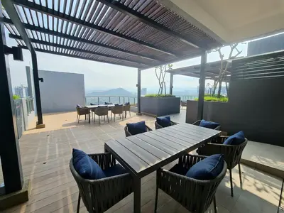 a patio with a wooden table and chairs with a view at Compact Studio Near Gleneagles KLCC in Kuala Lumpur