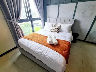 a bedroom with a bed with two towels on it at Compact Studio Near Gleneagles KLCC in Kuala Lumpur