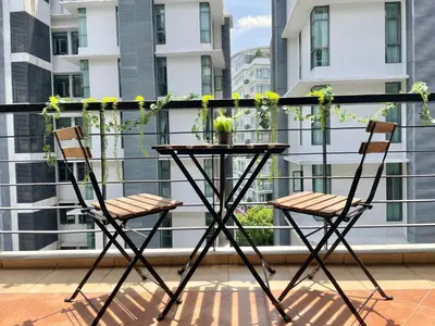 a table and two chairs on a balcony at Holiday Place Residence Kuala Lumpur in Kuala Lumpur