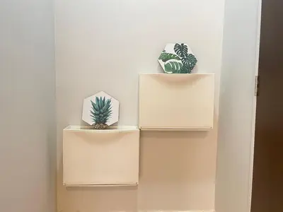 two shelves with plants on them on a wall at Holiday Place Residence Kuala Lumpur in Kuala Lumpur
