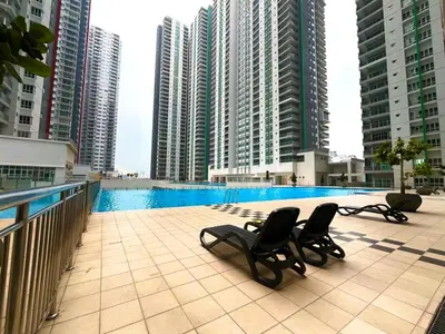 two chairs sitting on a balcony with tall buildings at Raay Home at Razak City Residence KL in Kuala Lumpur