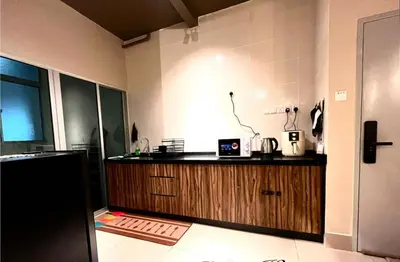 a kitchen with a refrigerator and a counter top at Raay Home at Razak City Residence KL in Kuala Lumpur