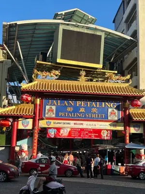 a building with a sign for a restaurant with people at Near in Kuala Lumpur