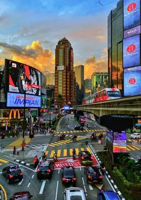 a busy city intersection with cars on a busy street at Near in Kuala Lumpur