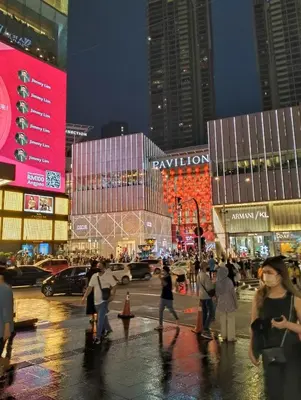 a group of people crossing a busy city street at night at Near in Kuala Lumpur