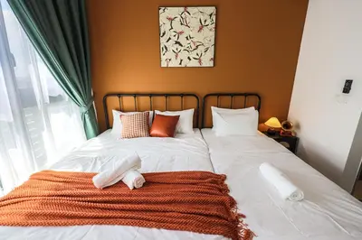 a bed with a blanket and pillows on it at M Vertica Home Plus in Kuala Lumpur