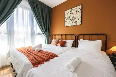a bedroom with two beds with white sheets and a window at M Vertica Home Plus in Kuala Lumpur