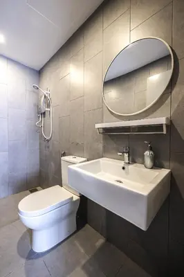 a bathroom with a sink and a toilet and a mirror at M Vertica Home Plus in Kuala Lumpur