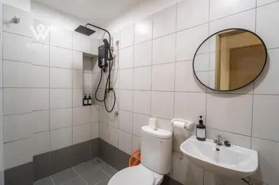 a bathroom with a toilet and a sink and a mirror at 6 pax Modern 3BR Stay in Sentul near KL City in Kuala Lumpur