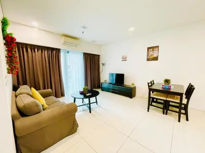 a living room with a couch and a table at Luxury Mercu Summer Suites KLCC By Majestic in Kuala Lumpur