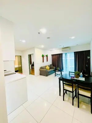 a living room with a table and a couch at Luxury Mercu Summer Suites KLCC By Majestic in Kuala Lumpur