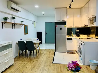 a kitchen with a refrigerator and a table with chairs at Luxury Mercu Summer Suites KLCC By Majestic in Kuala Lumpur