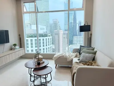 a living room with a couch and a large window at Soho Suites KLCC by City Keys in Kuala Lumpur