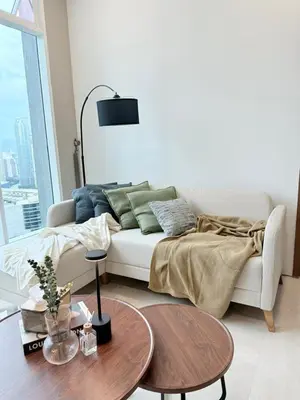a living room with a white couch and a table at Soho Suites KLCC by City Keys in Kuala Lumpur