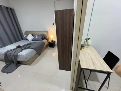 a bedroom with a bed and a table and a mirror at Regalia KLCC Pavilion Ceylon Jalan Alor 8 PAX 2R2B in Kuala Lumpur