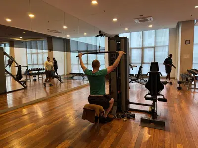 a woman in a gym with her arms in the air at Regalia KLCC Pavilion Ceylon Jalan Alor 8 PAX 2R2B in Kuala Lumpur