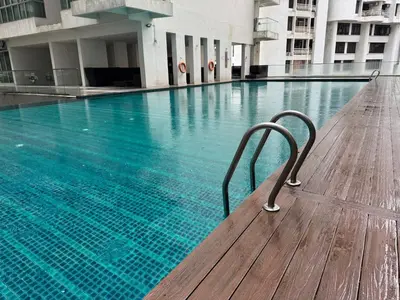 a swimming pool with a bench in a building at Regalia KLCC Pavilion Ceylon Jalan Alor 8 PAX 2R2B in Kuala Lumpur