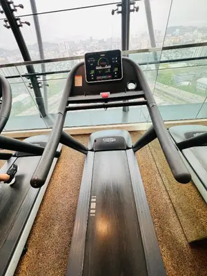 an empty treadmill in a building with a large window at M City by Celestia Suites in Kuala Lumpur