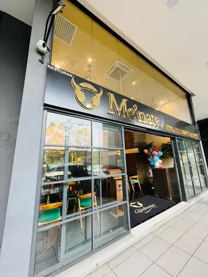 a restaurant with a sign on the side of a building at M City by Celestia Suites in Kuala Lumpur